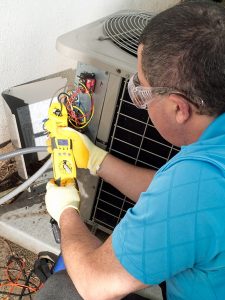 hvac-technician-performing-air-conditioner-repair