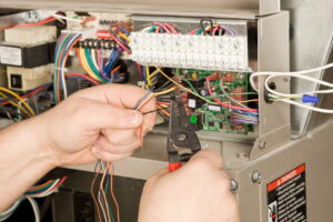 electrician-snipping-furnace-wires